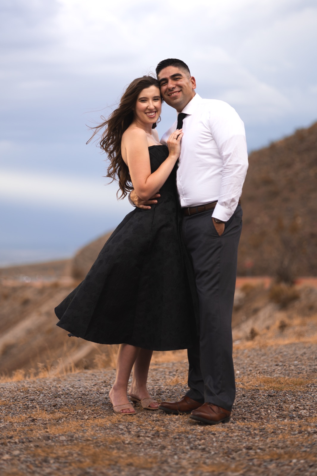A couple embracing in a desert landscape