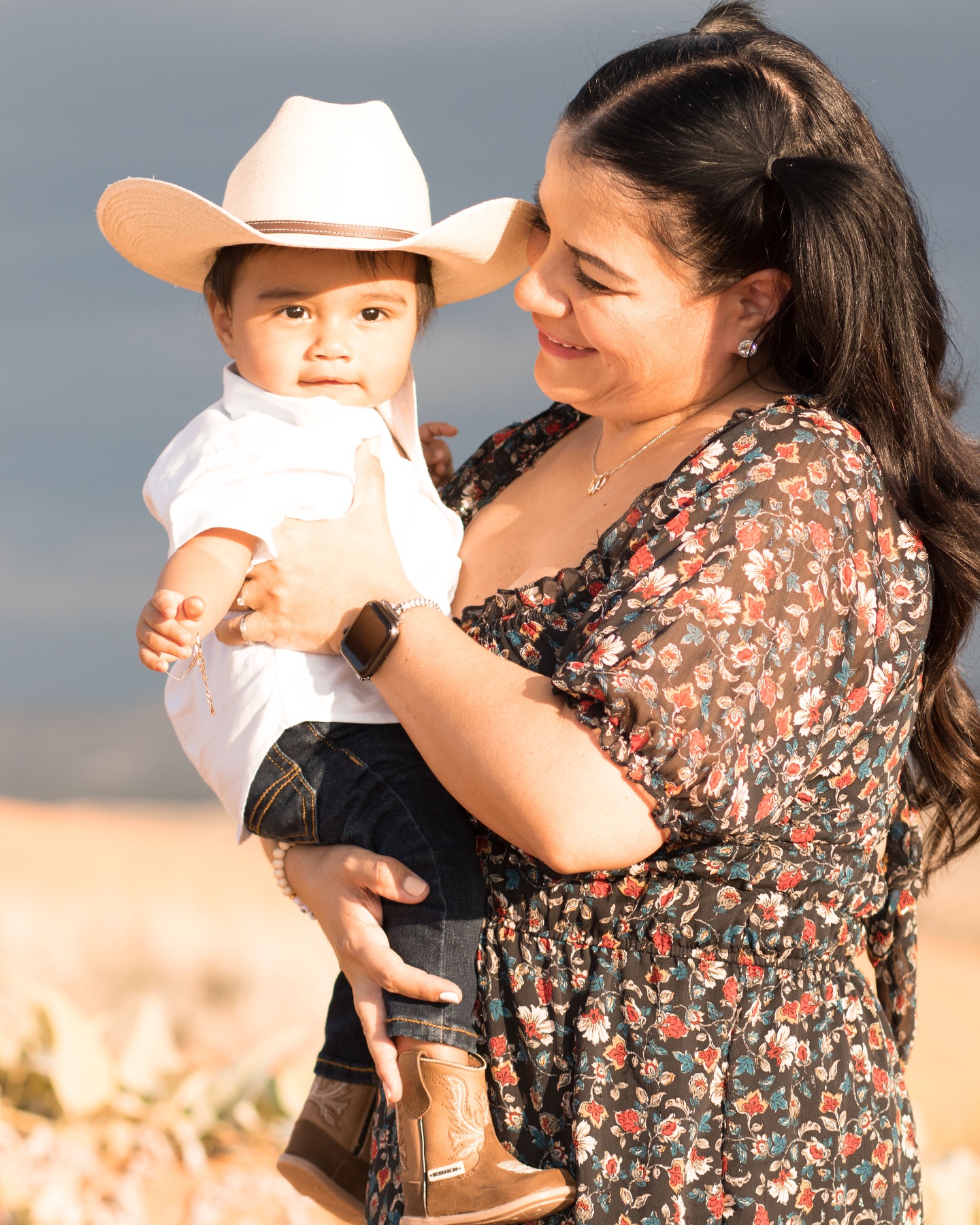 A mother holding her baby in warm desert light