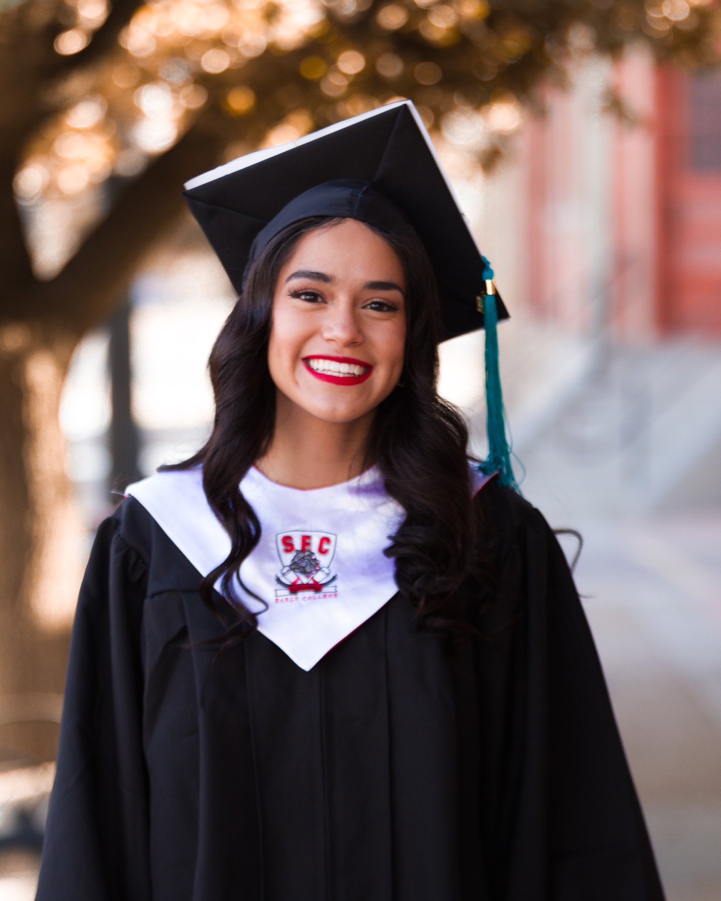 Katy smiling in her graduation cap and gown