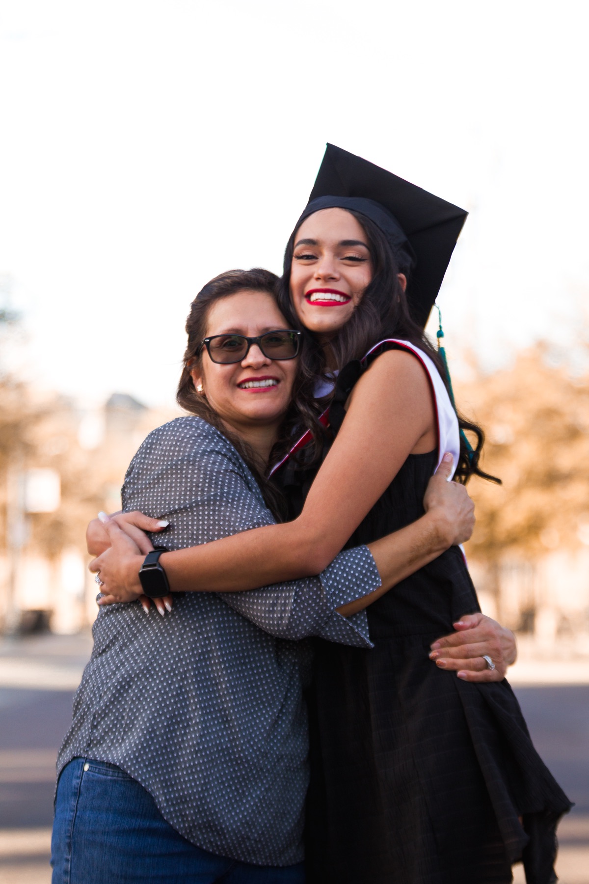 Katy sharing a hug with a loved one at her graduation session