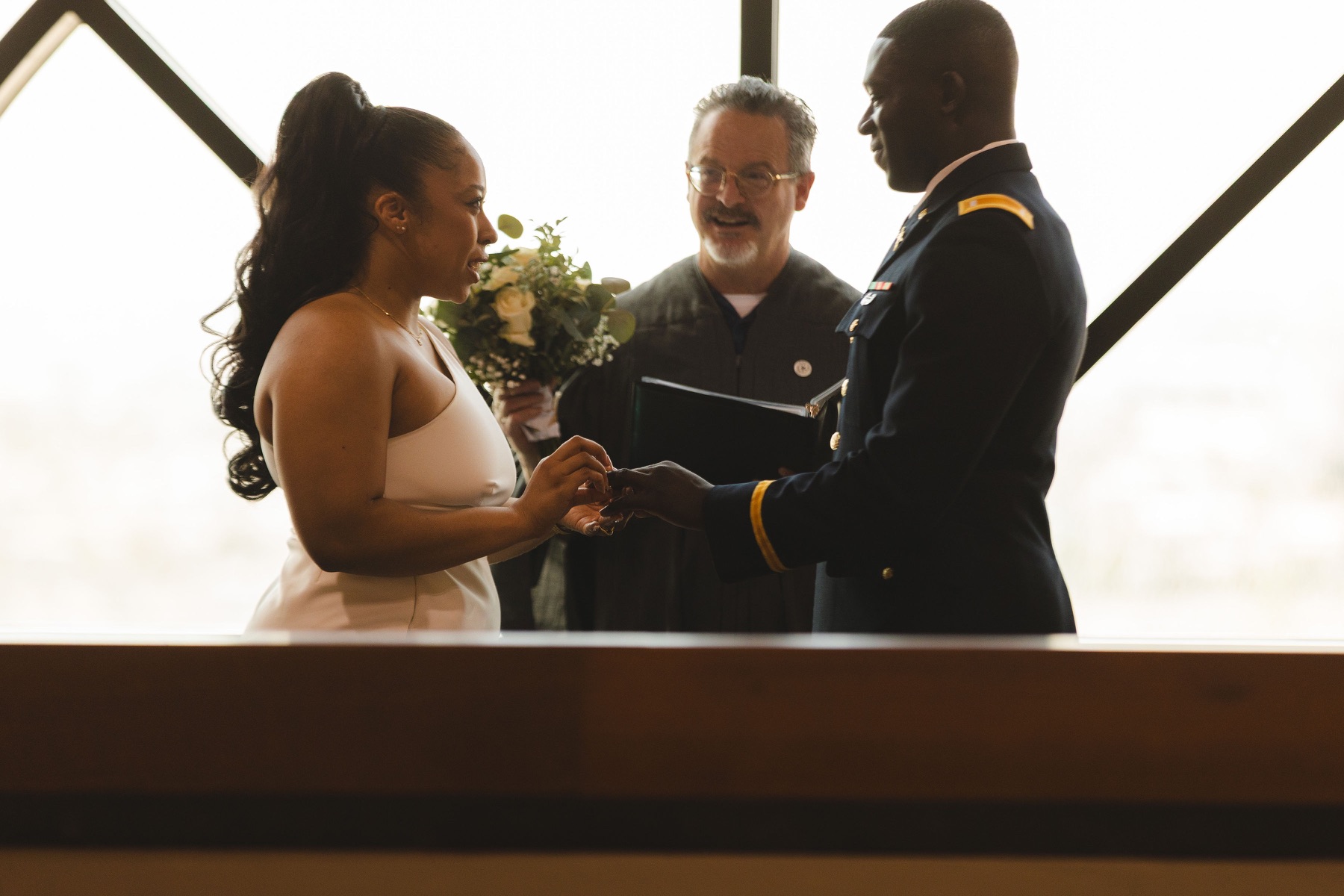 Ayo and Jordin exchanging vows with their officiant