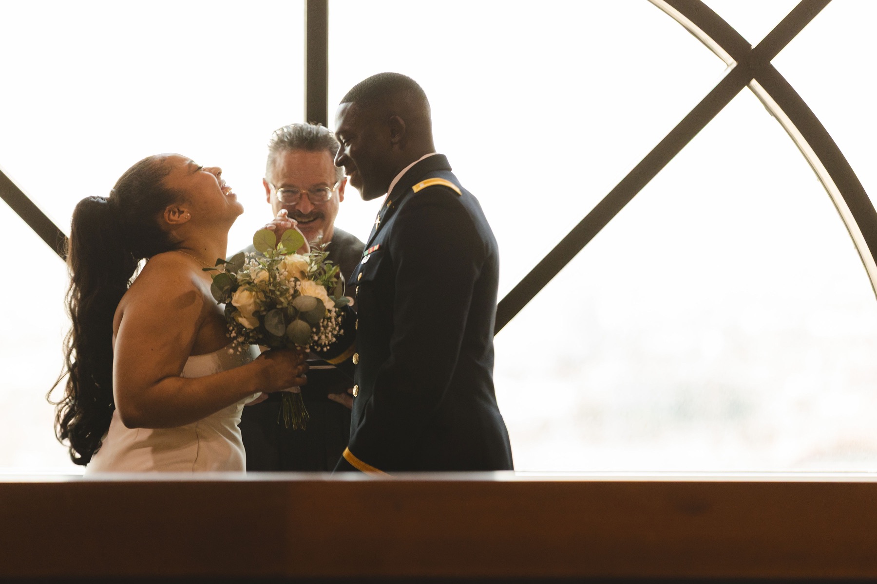 Ayo and Jordin smiling together during their courthouse ceremony